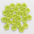 Closeup detail of light green flower shaped two hole buttons, perfect for craft accessories. - Flower Buttons / 13mm (24 Pieces/Pack) / Light Green