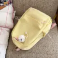 Yellow casual canvas backpack with cute plush charm, spacious daypack for women travel. - With Charm / Yellow