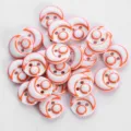 Close up detail of colorful resin buttons with two holes and orange crescent pattern for shirts. - 12.5mm / 06