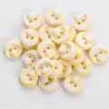 Close-up view of colorful resin buttons, two hole design with fine yellow pattern. - 12.5mm / 09