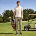 Golf course scene detail showing breathable athletic trousers for men, outdoor sportswear. - S / Bottoms / Oatmeal