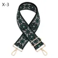 Detailed view of wide embroidered bag strap with ethnic patterns and gold hardware. - X-3 Black Green