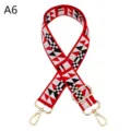 Detailed view of a colorful ethnic style bag strap with adjustable gold metal hardware. - A6