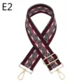Close-up of ethnic geometric pattern bag strap with gold metal hardware and adjustable buckle. - E2