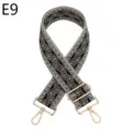 Detailed view of the ethnic geometric woven bag strap with adjustable gold metal hardware. - Gold / E9