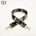 Camouflage bag strap detail shot, showing adjustable gold metal hardware and sturdy fabric. - Q1