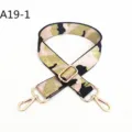 Detailed view of the pink and black camo handbag strap with shiny gold swivel hooks and buckle. - A19-1