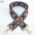 Detailed view of the ethnic style jacquard bag strap with adjustable metal hardware. - Gold / C-6 Black Burgundy Floral