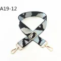 Close-up detail of the adjustable jacquard camo bag strap with durable gold-tone hardware. - A19-12