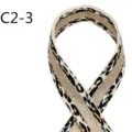 Detailed close-up shot of ethnic style leopard print jacquard webbing with metallic gold thread. - C2-3