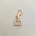 Rose gold metal lobster clasp detail, swivel snap hook hardware for bags and keychains. - Gold