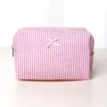 Pink striped cosmetic bag with cute bow, portable makeup pouch for daily travel use. - Red Pleated Medium Cosmetic Bag with Bow