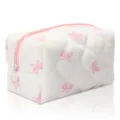 Detailed view of white quilted cosmetic bag with pink bows, showing fabric and zipper. - Pink Butterfly Print Bow Quilted Padded Cosmetic Bag