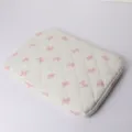 Quilted laptop sleeve detail showcasing cute pink bow patterns and soft cotton-padded design. - 14" / Bowknot Pink