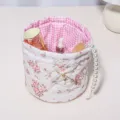Detailed view of cute floral quilted storage basket with pink checkered lining and pearl handle. - 18x15 / Large Floral [Lace Quilted Cylindrical Storage Basket]