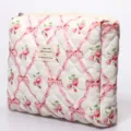 Quilted cosmetic bag with pink floral ribbon print, soft padded zipper storage pouch. - Bow Red Floral Cosmetic Bag