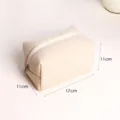 Corduroy cosmetic bag detail view showing compact size, convenient for travel and daily storage. - Milky White Corduroy Medium Cosmetic Bag