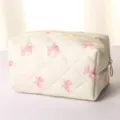 Quilted cosmetic bag for women, soft travel makeup pouch with cute bow pattern and zipper. - Quilted White Pink Bow Pillow Bag