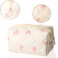 Detail view of quilted cosmetic bag featuring pink bow pattern and smooth zipper closure. - White Pink Butterfly Bow Print Quilted Padded Cosmetic Bag
