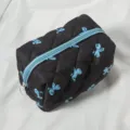 Black quilted cosmetic bag with blue bow print, travel zipper pouch for daily storage. - Quilted Black Blue Bow Square Bag