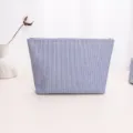 Blue and white striped fabric cosmetic bag detail, featuring durable zipper closure and neat stitching. - Blue Pleated Large Cosmetic Bag