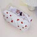 Close-up detail of white quilted cherry print cosmetic and hair styling tool storage bag. - Cherry Fruit Curling Wand Storage Bag