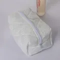 White quilted embroidered cosmetic bag, portable cotton toiletry pouch for travel and daily use. - Quilted Hollow-Out Embroidered Cosmetic Bag