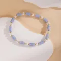 Vista dettagliata del braccialetto di perle elegante con perline cilindriche blu e distanziatori. - 16#