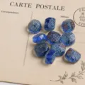 Vue détaillée de perles ovales facettées en verre tchèque vintage 10x14mm pour bijoux DIY. - Bleu Cristal Fumé