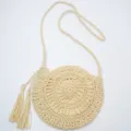 Beige round straw crossbody bag with chic tassel and woven strap for beach holiday vacation. - Edge Zipper / Off White