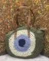 Round straw woven shoulder bag for women, handmade beach handbag with evil eye pattern. - Green with Blue Core
