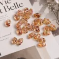 Detailed view of Czech glass butterfly beads double hole DIY jewelry making components. - 10g (Approx 110 Beads) / Honey Champagne