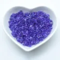 Purple glass triangle seed beads packed in a white heart bowl for jewelry making crafts. - Color TR05-1141
