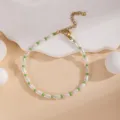 Close-up of a charming beaded bracelet with white and green elements and adjustable chain. - Pearl Green