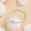 Minimalist turquoise seed bead bracelet with gold accents and central stone for daily wear. - Style #6