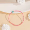 Delicate beaded detail showing pink seed beads, gold accents and a natural turquoise stone bead. - Style #8