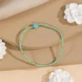 Close-up detail of minimalist ethnic woven seed bead bracelet with turquoise stone accent. - Style 14