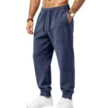 Close-up detail of men's blue fleece sweatpants featuring an adjustable elastic drawstring waist. - Navy Blue