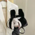 Black fluffy faux fur handbag with plush rabbit pendant and metallic lock. Stylish chic design. - Black
