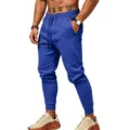 Detailed view of men's solid blue fleece sweatpants with elastic drawstring waist and cuffed hem. - S / Bottoms / Sapphire Blue