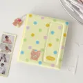 Yellow polka dot photocard binder detail, cute bear pendant, aesthetic Kpop album storage. - Yellow