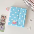 Detail view of a cute Korean style polka dot photo card binder with adorable pendant accessory. - Blue