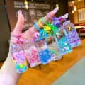 Close-up detail of colorful liquid glitter keychain bottles with cute bells, creative hanging accessory. - Luminous Bubble Bead (Colored Hardware) / Lobster Clasp Style / Multicolor