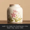 Petite boîte à thé en céramique avec motif de marguerites roses, récipient de stockage portable. - Cendres de Paille Peint à la Main Marguerite Boîte à Thé Élégante