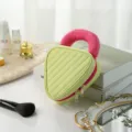 Stylish portable cosmetic bag with unique triangle design and pink handle for daily makeup storage. - Soda Color-Block Small Green