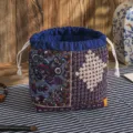 Traditional Chinese style patchwork storage bag with retro quilted design and drawstring closure. - Floral Weave