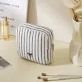 Black and white striped quilted cosmetic bag with cute bow for portable daily travel storage. - Sanitary Napkin Pouches / Striped Black