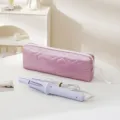 Pink quilted heart travel storage bag with hair styling tool for portable daily use. - Pink