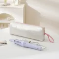 Portable travel quilted heart storage bag with pink zipper and electric hair curler set for daily use. - White