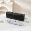 Black heart quilted travel storage bag with purple curling iron, portable and durable. - Black